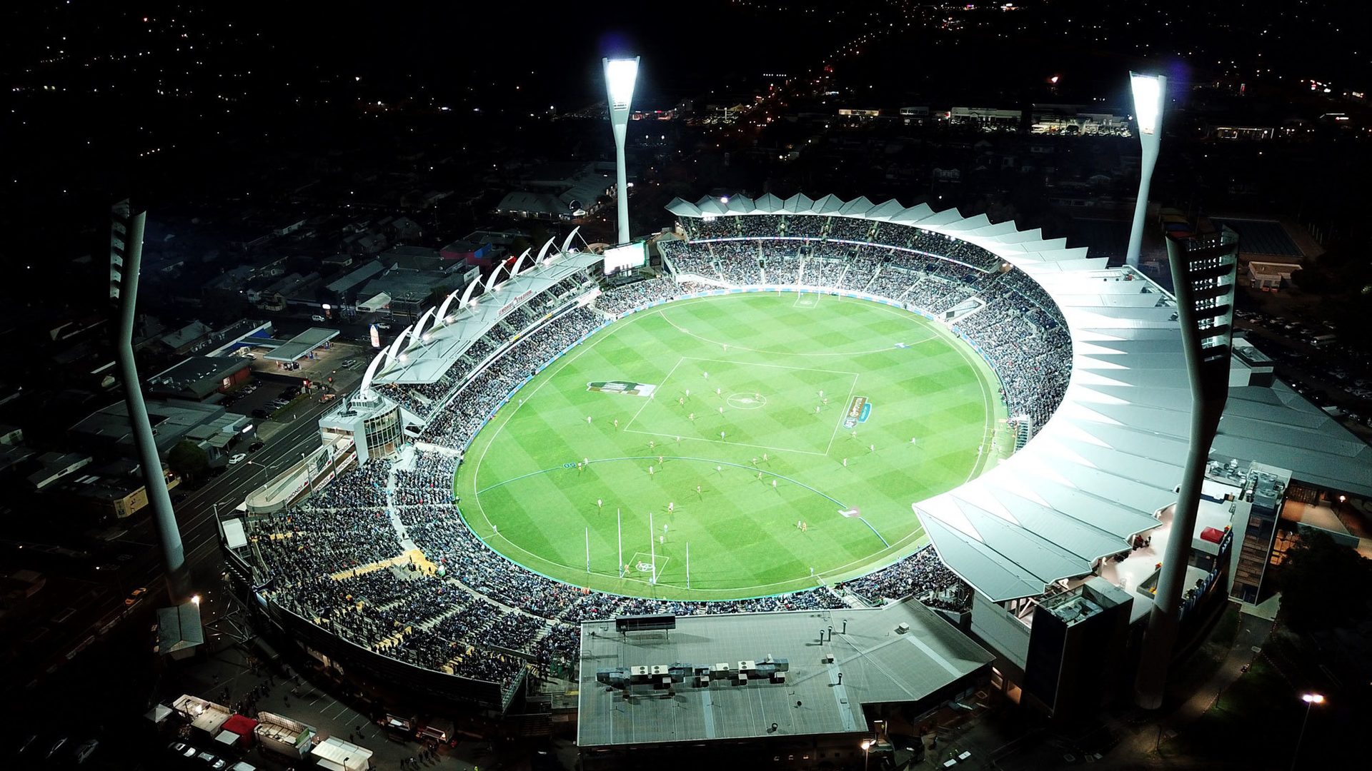 An aerial view of a floodlit stadium
